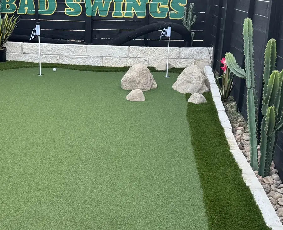 The bank-shot feature: artificial rocks on the putting green hiding liftable utility access